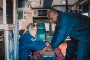 Paramedics helping patient in ambulance